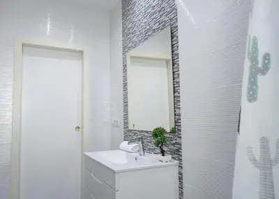 a white bathroom with a sink and a mirror at VILLA 5 PLAYA A 2 MINUTOS in Castelldefels