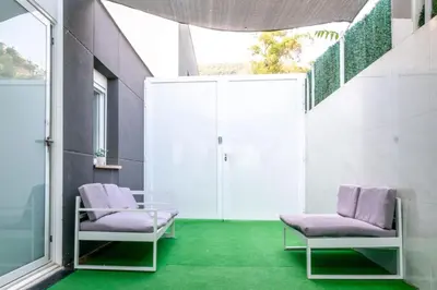 a room with two chairs and a glass table at VILLA 5 PLAYA A 2 MINUTOS in Castelldefels