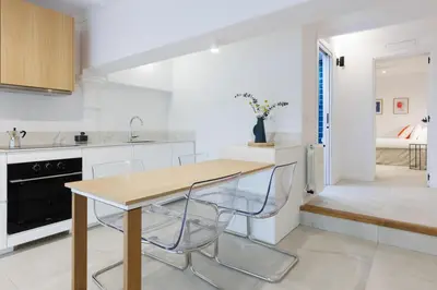 a kitchen with a wooden table and chairs at Stylish Apartment near Plaça España in Barcelona