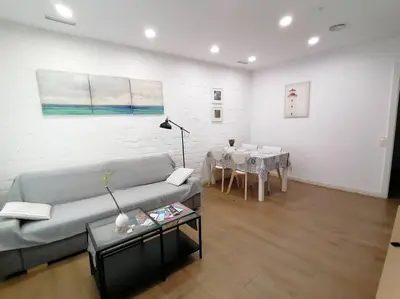 a living room with a couch and a table at Apartamento PB 30min Sagrada Familia, 10 min playa in Badalona