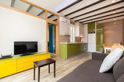 a living room with a tv and a couch at Stay Barcelona Charming Gracia in Barcelona