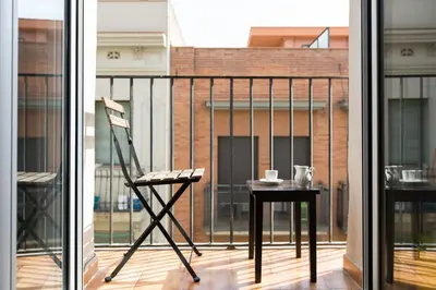 a chair and a table on a balcony at Stay Barcelona Charming Gracia in Barcelona