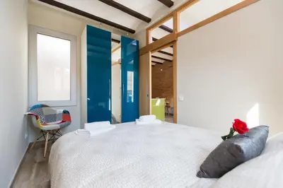 a bedroom with a large white bed and a window at Stay Barcelona Charming Gracia in Barcelona