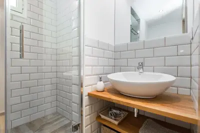 a white bathroom with a sink and a shower at Stay Barcelona Charming Gracia in Barcelona