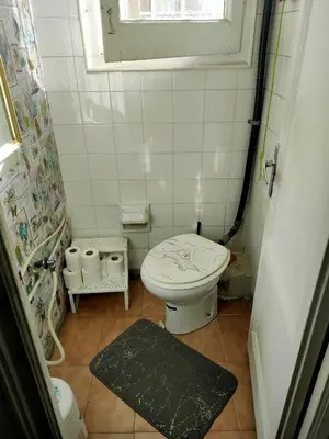 a small bathroom with a toilet and a window at Cozy apartament in Barcelona