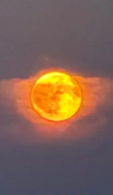 a yellow sun in the sky with a cloudy at Nuevos Apartamentos frente al mar y a la playa in Castelldefels