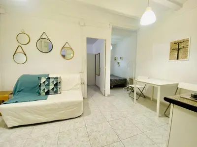 a living room with a bed and a desk at 017 New of love 3 1 in Barcelona