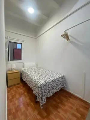 a bedroom with a bed and a table and a window at 017 New of love 3 1 in Barcelona