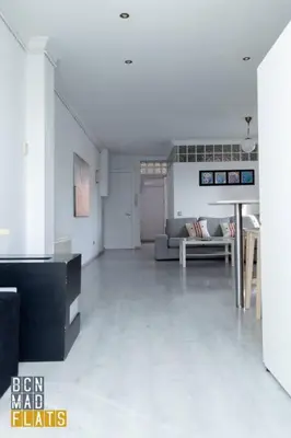 a living room with a couch and a table at Bcn - Poble Nou in Barcelona