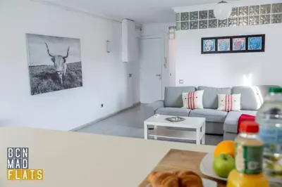 a living room with a couch and a cow on the wall at Bcn - Poble Nou in Barcelona
