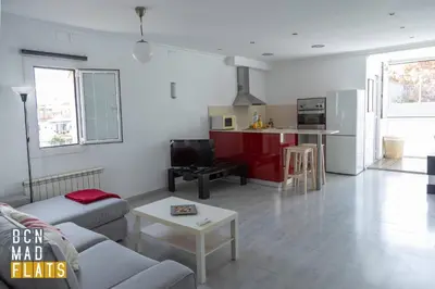 a living room with a couch and a table at Bcn - Poble Nou in Barcelona