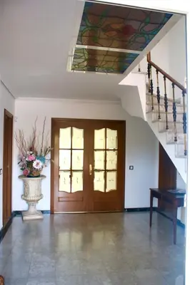 a room with a staircase and a painting on the ceiling at MAGNÍFICA RESIDENCIA in Masnou