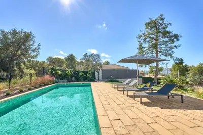 a swimming pool with two lounge chairs and an umbrella at Casa Brisa Boutique Guest House - Gay Men Only in Sant Pere de Ribes