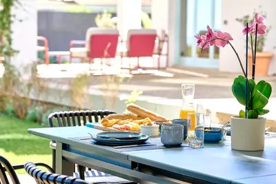 a blue table with a plate of food on it at Casa Brisa Boutique Guest House - Gay Men Only in Sant Pere de Ribes