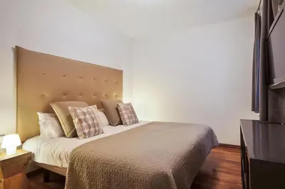 a bedroom with a large bed with pillows on it at Canela Homes BARCELONA UNIVERSITAT in Barcelona