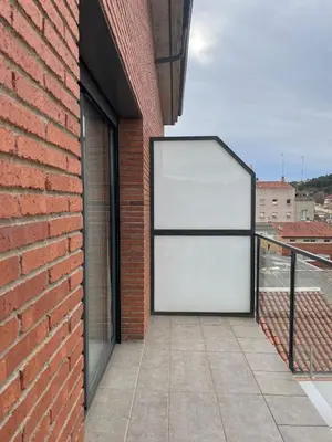 a large white sign on the side of a brick building at Luminoso dúplex con parking in Terrassa
