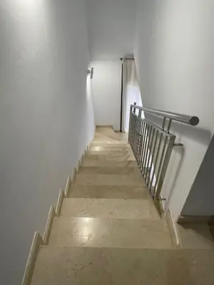 a stairway with a metal railing and a stair case at Luminoso dúplex con parking in Terrassa