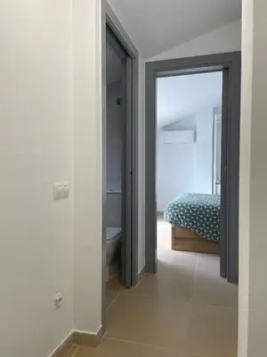 a bedroom with a door leading to a bed at Luminoso dúplex con parking in Terrassa