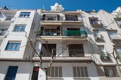 a tall white building with windows and balconies at Hola! - Sitges Centric Apartment in Sitges