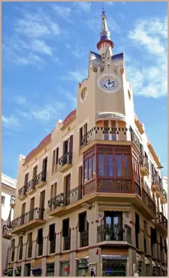 a building with a clock tower on top of it at Hola! - Sitges Centric Apartment in Sitges