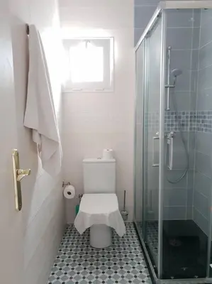 a bathroom with a toilet and a glass shower at Hola! - Sitges Centric Apartment in Sitges