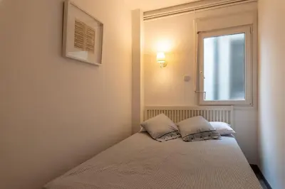 a bed in a room with a window at Centric and spacious, excellent for families in Barcelona