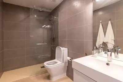 a bathroom with a toilet and a sink and a shower at Centric and spacious, excellent for families in Barcelona