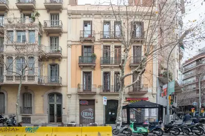 a building with motorcycles parked in front of it at Barcelona Eixample in Barcelona