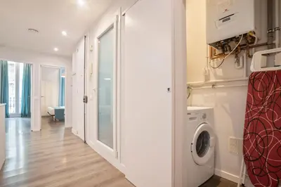 a laundry room with a washer and dryer at Barcelona Eixample in Barcelona