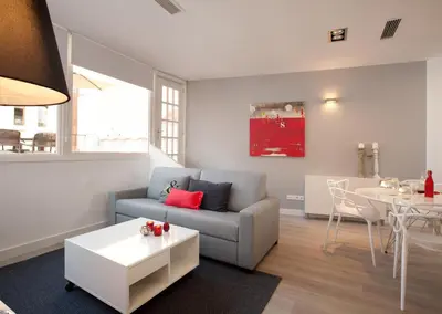 a living room with a couch and a table at Click&Flat Seneca Suites in Barcelona