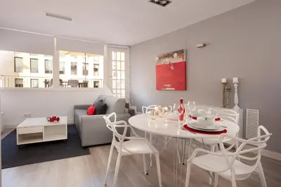 a living room with a white table and chairs at Click&Flat Seneca Suites in Barcelona