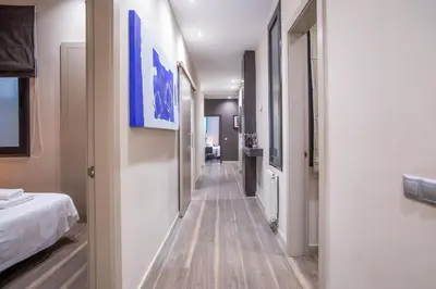 a corridor of a hospital room with a bed and a hallway at Tendency Apartments 9 in Barcelona