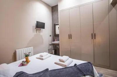 a bedroom with two beds with white cabinets at Tendency Apartments 9 in Barcelona