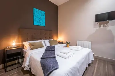 a bedroom with a large bed with two towels on it at Tendency Apartments 9 in Barcelona