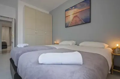 two beds in a room with two white beds at Apartment Marti in Barcelona