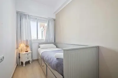 a small bedroom with a bed and a window at Apartment Marti in Barcelona