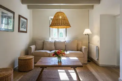 a living room with a couch and a table at Finca Can Romeu: alojamiento rural entre viñedos in Font-Rubí