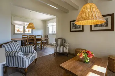 a living room with two chairs and a table at Finca Can Romeu: alojamiento rural entre viñedos in Font-Rubí