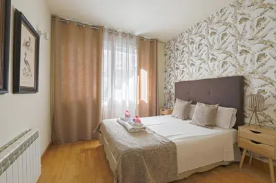 a bedroom with a bed and a large window at Alcam Gold in Barcelona
