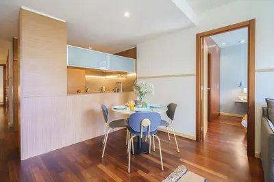 a kitchen and dining room with a table and chairs at Aspasios Diagonal Art Apartments in Barcelona