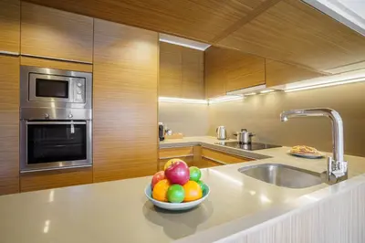 a bowl of fruit on a counter in a kitchen at Aspasios Diagonal Art Apartments in Barcelona