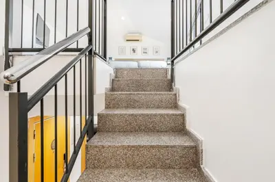 a staircase in a house with a yellow surfboard at AB Besòs River Apartment in Sant Adria de Besos