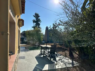 a patio with a table and an umbrella at Tu Casa en Barcelona in Sant Cugat del Vallès