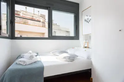 a white bedroom with a sink and a bed at Les Corts Exclusive Apartments by Olala Homes in Barcelona
