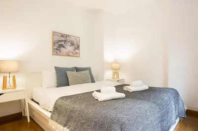 a bedroom with a bed with two towels on it at Les Corts Exclusive Apartments by Olala Homes in Barcelona