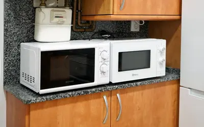 a microwave sitting on a counter in a kitchen at MarBarcelona Suites Berlin in Barcelona
