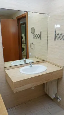 a bathroom with a sink and a large mirror at MarBarcelona Suites Berlin in Barcelona