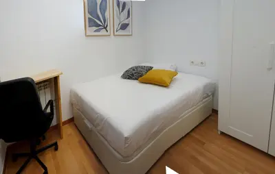 a bed in a room with a desk and a chair at MarBarcelona Suites Berlin in Barcelona