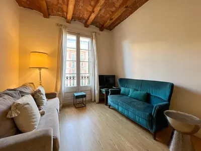 a living room with a couch and a television at Stay U-nique Apartment Arago II in Barcelona