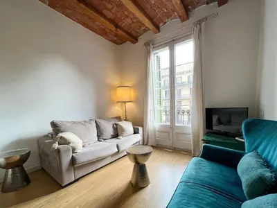 a living room with a couch and a tv at Stay U-nique Apartment Arago II in Barcelona